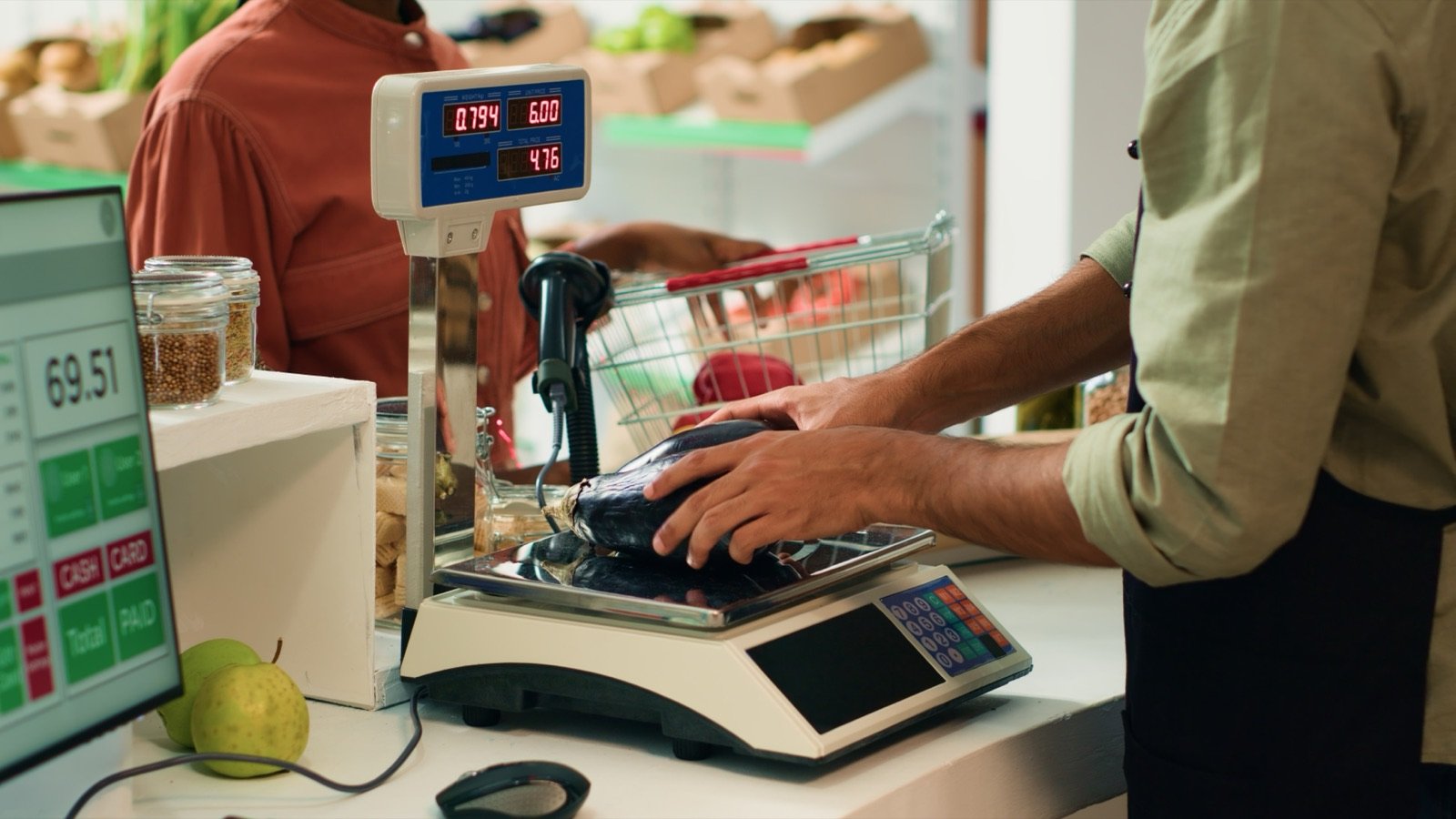 ¿Cómo conectar una balanza al punto de venta (POS) de tu negocio? 1 Comerciante pesando frutas en una balanza conectada al punto de venta